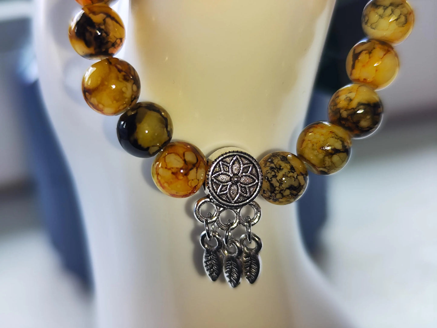 Yellow-orange bracelet with dreamcatcher pendant